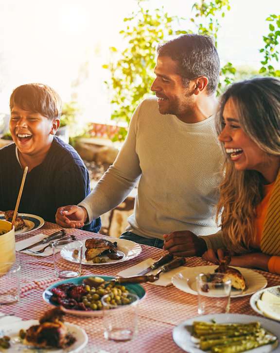 A group of people enjoying a meal together at a restaurant.