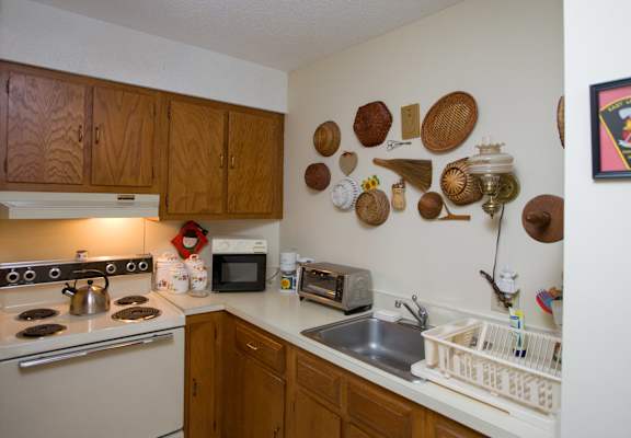 a kitchen with a stove top oven and a sink