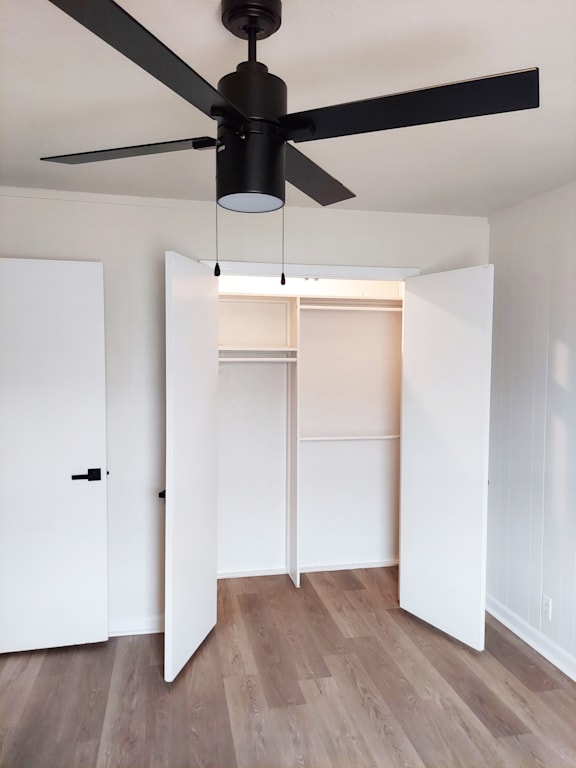 a room with white closets and a ceiling fan