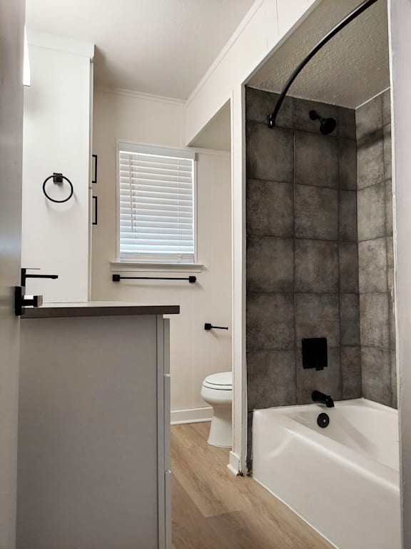 a small bathroom with a shower and a sink and a toilet