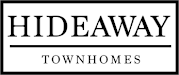 A black and white sign that says Hideaway Townhomes.