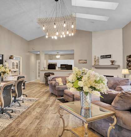 a living room with couches and a dining table