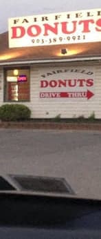 a donut shop with a sign on the front of it