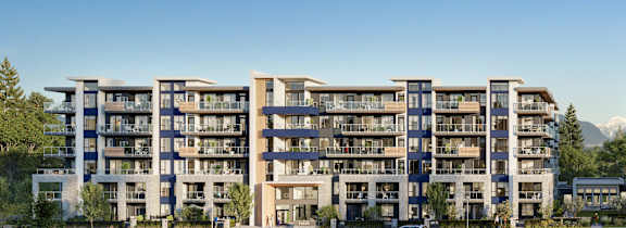 A large apartment complex with multiple buildings and a parking lot in front.