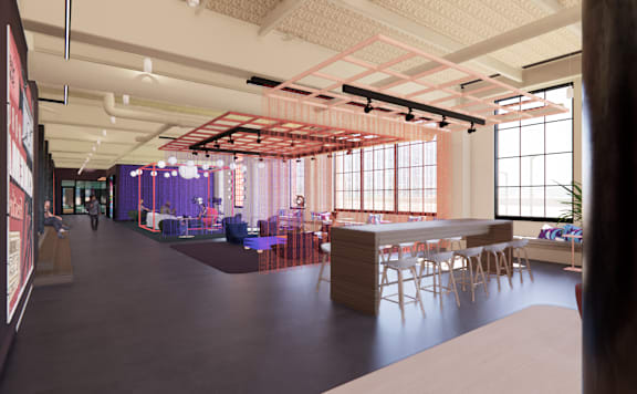 A modern office space with a long table and chairs.