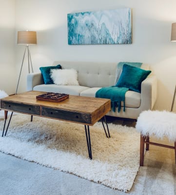 Tan couch with blue accents and table