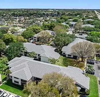 A bird's eye view of a residential area with houses and cars.