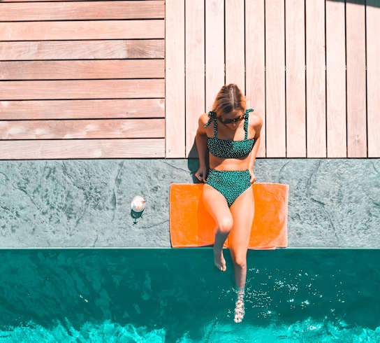 a woman in a green bikini jumping into a pool at Allure Apollo, Camp Springs, Maryland, 20746