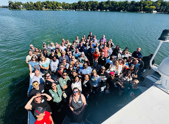 A group of people are posing for a photo on a boat.