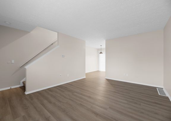 an empty living room with white walls and a white door