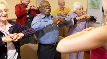 Elderly people doing a group exercise