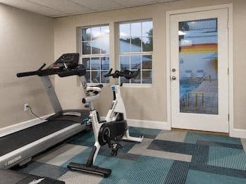a gym with a exercise bike and a window