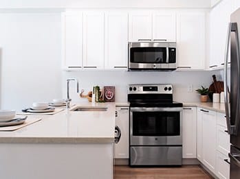 a kitchen with a stove a sink and a microwave