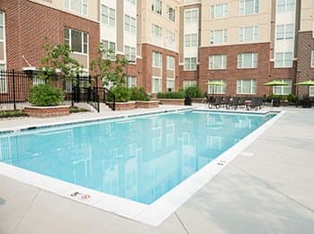 a swimming pool in front of an apartment building