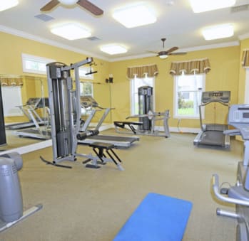 a large fitness room with a lot of exercise equipment