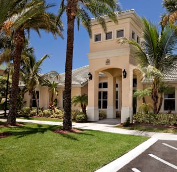 a large house with palm trees in front of it
