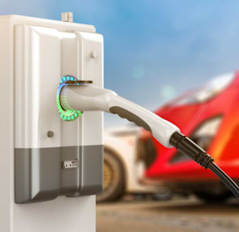 a white electric toothbrush plugged into a white surge protector