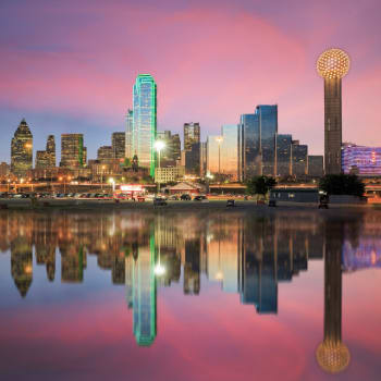 a view of the dallas skyline at sunset