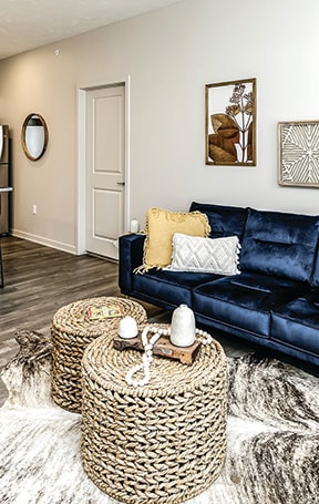 A living room with a blue couch at Tiburon Ridge, Omaha, Nebraska