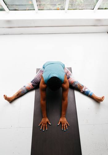 A person in a yoga pose on a mat.