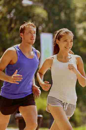 a man and a woman running in the park