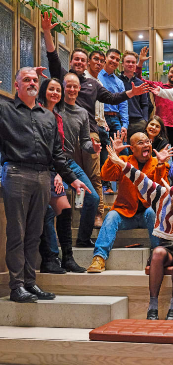 a group of people standing and sitting on the stairs