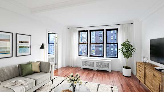 A living room with a grey couch, a white bench, a television, and a plant.at Sutton Collection, New York, NY