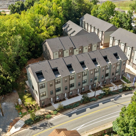 a row of townhomes with brick and gray buildings at The Collection Charlotte in Charlotte, NC, 28205