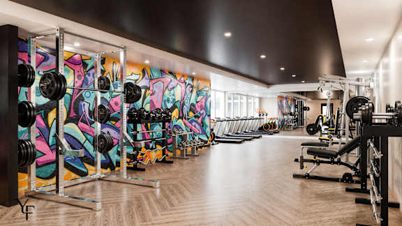 A gym with a row of weightlifting equipment.