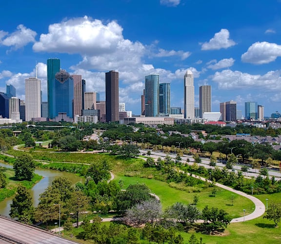 an aerial view of the city skyline and a park at Tranquility Grove, Texas 77090