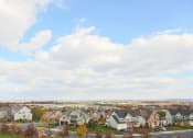 Thumbnail 1 of 23 - exterior view from VistaView apartments in Frederick, MD  with blue sky and clouds with scattered homes at VistaView, Maryland, 21702
