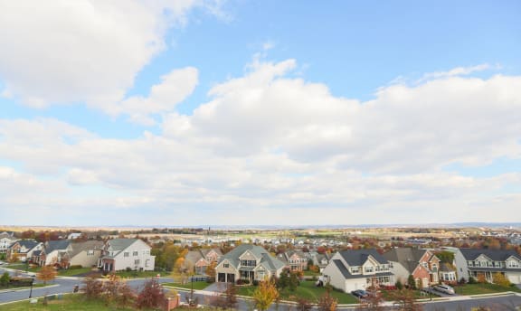 exterior view from VistaView apartments in Frederick, MD  with blue sky and clouds with scattered homes at VistaView, Maryland, 21702