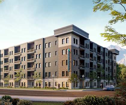 A modern apartment building with a mountain in the background.