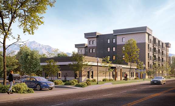 A modern building with a parking lot in front of it.