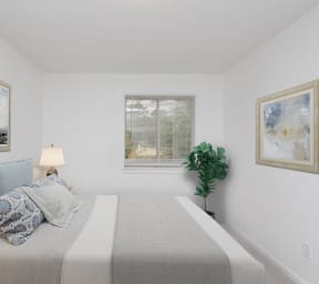 a bedroom with a bed and paintings on the wall