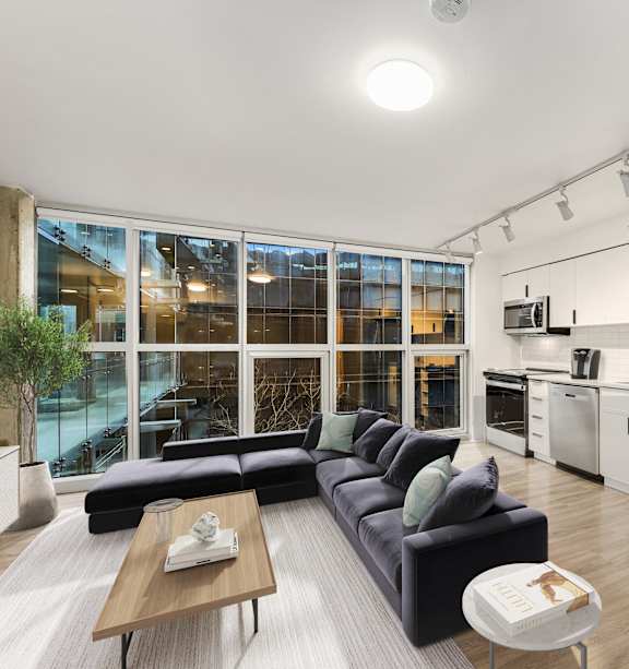 an empty living room with wood flooring and a large window