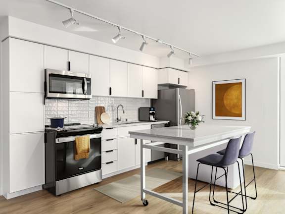A modern kitchen with black appliances and white cabinetry.
