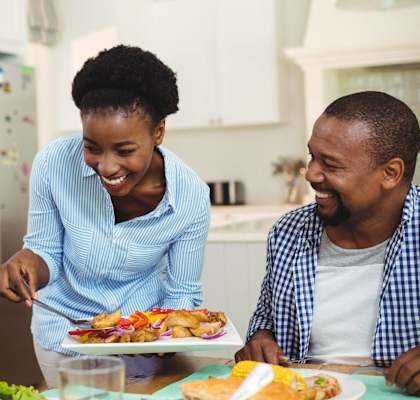 A family enjoying a meal together in their kitchen at Clarkston Station Apartments, Georgia 30021