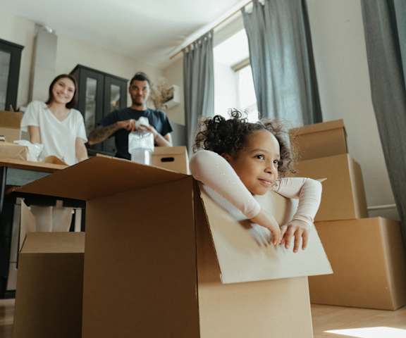 a group of people sitting in boxes in a room