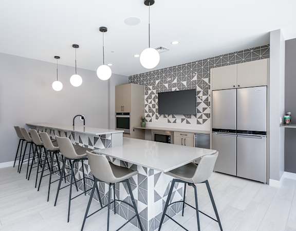 a kitchen with a long island with a white countertop