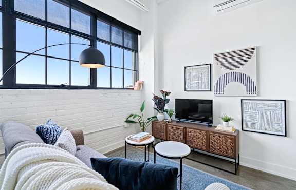 a living room with a couch and a large window