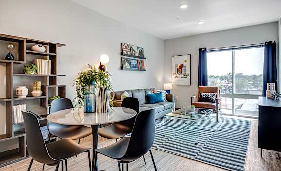 a living room with a table and chairs and a couch