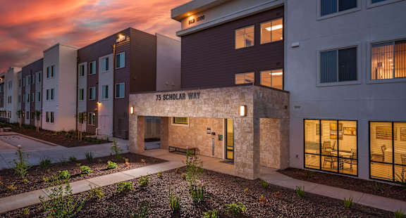 a building with a sunset in the background