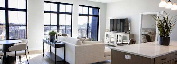 a rendering of a living room and dining room with windows