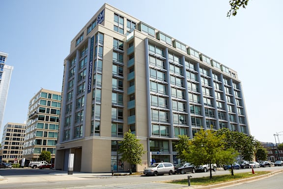 A large building with many windows is in the foreground.