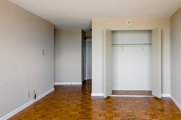 A room with a wooden floor and a white wall at Hampton Plaza Apartments, Towson, MD, 21286