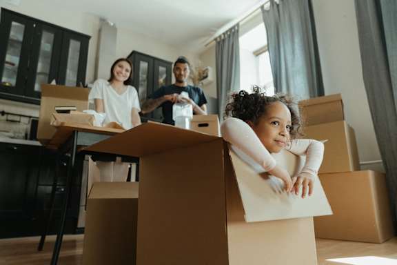 a group of people sitting in boxes in a room