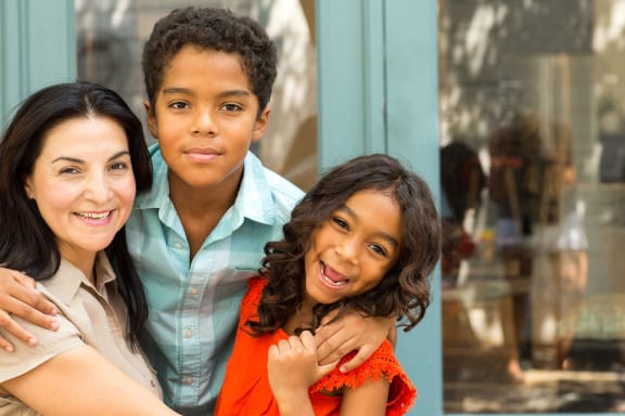 a boy and two women are posing for a picture