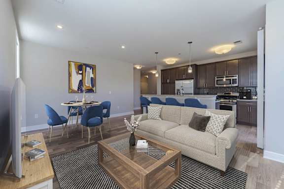 A living room with a couch, chairs, and a coffee table.