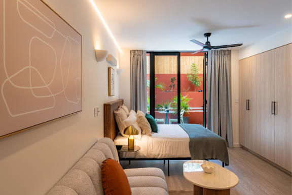 a bedroom with a bed and a couch in a hotel room